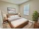 Cozy bedroom with wood-look floors, a comfortable bed and a neutral color palette for a relaxing retreat at 12316 Durango Ave, North Port, FL 34287