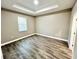 Spacious bedroom featuring tray ceiling, wood floors and natural light at 12316 Durango Ave, North Port, FL 34287