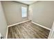Empty bedroom featuring wood floor, window and white trim at 12316 Durango Ave, North Port, FL 34287