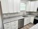 Beautiful kitchen featuring granite countertops, stainless steel appliances, and bright white cabinetry at 12316 Durango Ave, North Port, FL 34287