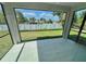 Enclosed lanai with tile flooring offers panoramic views of the fenced backyard and lush greenery at 12316 Durango Ave, North Port, FL 34287