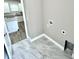 Bright laundry area features marble tile flooring and is conveniently located near the kitchen at 12316 Durango Ave, North Port, FL 34287