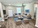 Inviting living room with stylish decor, comfortable seating, and a ceiling fan for added comfort at 12316 Durango Ave, North Port, FL 34287