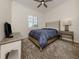 Comfortable bedroom with a bed, side table, natural light, and a relaxing ambiance at 129 Cipriani Way, North Venice, FL 34275