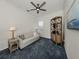 Cozy bedroom with a comfortable sofa, ample lighting, and a relaxed atmosphere at 129 Cipriani Way, North Venice, FL 34275