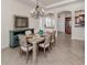 Charming dining room featuring a rustic table, chandelier, and stylish accents, perfect for gatherings at 129 Cipriani Way, North Venice, FL 34275