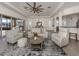Comfortable living room with neutral decor, open to the dining area and featuring sliding doors to the screened lanai at 129 Cipriani Way, North Venice, FL 34275
