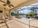 Inviting screened-in pool area featuring a spa, waterfall, and comfortable seating, offering a relaxing outdoor retreat at 129 Cipriani Way, North Venice, FL 34275