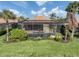 View of screened in pool and spa with lush landscaping and blue skies at 129 Cipriani Way, North Venice, FL 34275