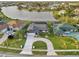 Waterfront property with lush landscaping, circular driveway, and screened-in pool at 1300 Lucaya Ave, Venice, FL 34285