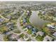 Aerial shot of residential properties situated along a scenic canal, showcasing well-kept lawns and community roads at 1300 Lucaya Ave, Venice, FL 34285
