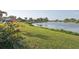 Lush backyard with a serene lake view at 1300 Lucaya Ave, Venice, FL 34285