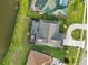 Aerial view of a screened-in pool overlooking the water, perfect for relaxing at 1300 Lucaya Ave, Venice, FL 34285