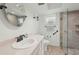 Bathroom with marble walk-in shower, white vanity, and classic fixtures at 1300 Lucaya Ave, Venice, FL 34285