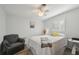 Well-lit bedroom featuring a ceiling fan, comfortable chair, and stylish decor at 1300 Lucaya Ave, Venice, FL 34285