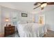 Comfortable bedroom features wood-look flooring, shuttered windows, and a ceiling fan at 1300 Lucaya Ave, Venice, FL 34285