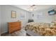 Bright bedroom features wood-look floors, ceiling fan, and large dresser at 1300 Lucaya Ave, Venice, FL 34285