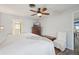 This bedroom includes wood-look floors, ceiling fan, and an en suite bathroom at 1300 Lucaya Ave, Venice, FL 34285
