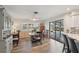 Light-filled dining room with a view of the pool, wood accents, and a table for four at 1300 Lucaya Ave, Venice, FL 34285