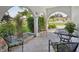 Open-air porch featuring comfortable seating, decorative plants, and views of the surrounding greenery at 1300 Lucaya Ave, Venice, FL 34285