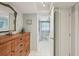 Hallway leading to a charming bathroom with white tile flooring at 1300 Lucaya Ave, Venice, FL 34285