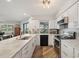 Clean and modern kitchen with white cabinets, granite countertops, and stainless steel appliances at 1300 Lucaya Ave, Venice, FL 34285