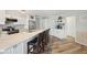 Updated Kitchen with white cabinets, long counter, and bar stools; lots of light and counter space at 1300 Lucaya Ave, Venice, FL 34285