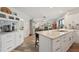 Bright kitchen with white cabinets, granite countertops, and views into dining area and bedroom at 1300 Lucaya Ave, Venice, FL 34285