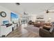Spacious living room with wood floors, comfortable seating, and a sliding glass door leading to the outdoors at 1300 Lucaya Ave, Venice, FL 34285