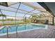 Screened-in pool with brick patio and lake view at 1300 Lucaya Ave, Venice, FL 34285