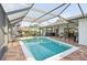 Screened-in pool with brick patio area and plenty of room for seating and grilling at 1300 Lucaya Ave, Venice, FL 34285
