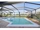 Screened-in pool and patio area with lake view and ample seating at 1300 Lucaya Ave, Venice, FL 34285