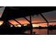 Stunning sunset view from the screened lanai overlooking the serene lake waters at 1300 Lucaya Ave, Venice, FL 34285
