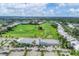Panoramic aerial view of the golf course and clubhouse, showcasing the sprawling greens and community amenities at 1330 Berkshire Ct, Venice, FL 34292