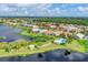 Community aerial view highlighting lakefront property, pool, gazebo, and mature landscaping at 1330 Berkshire Ct, Venice, FL 34292
