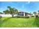 Backyard featuring a well-maintained lawn, manicured shrubbery, and a privacy fence at 1330 Berkshire Ct, Venice, FL 34292