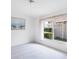 Bright bedroom with neutral carpeting and a large window overlooking the yard at 1330 Berkshire Ct, Venice, FL 34292