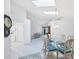 Open-concept dining area with skylights and adjacent to a living room and a laundry area at 1330 Berkshire Ct, Venice, FL 34292
