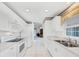 Galley kitchen with white cabinetry and stainless appliances at 1330 Berkshire Ct, Venice, FL 34292