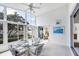 Enclosed lanai with a ceiling fan, glass windows, and a dining table with seating at 1330 Berkshire Ct, Venice, FL 34292