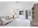 Bright living room with ceiling fan, neutral carpeting, and sliding doors to the lanai at 1330 Berkshire Ct, Venice, FL 34292
