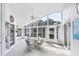 Bright sunroom with floor-to-ceiling windows, offering ample natural light and views of the backyard at 1330 Berkshire Ct, Venice, FL 34292