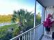 Balcony view shows tropical palms, plants, and waterway at 1401 S Mccall Rd # 106, Englewood, FL 34223