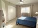 Cozy bedroom with tiled floors, ceiling fan, closet, and large window providing lots of natural light at 1401 S Mccall Rd # 106, Englewood, FL 34223