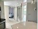 Open view from kitchen to bedroom featuring mirrored closet doors and access to an outdoor balcony area at 1401 S Mccall Rd # 106, Englewood, FL 34223