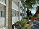 Exterior of building with balconies and lush landscaping, blending living with nature at 1401 S Mccall Rd # 106, Englewood, FL 34223