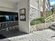 View of building entry with stairs, a bulletin board, and parking under the building at 1401 S Mccall Rd # 106, Englewood, FL 34223