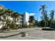 A condo building's exterior featuring palm trees and multiple stories of balconies at 1401 S Mccall Rd # 106, Englewood, FL 34223