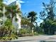 Exterior building with tropical plants and trees including palms at 1401 S Mccall Rd # 106, Englewood, FL 34223