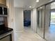 Hallway showing a partial view of a bedroom and sliding mirrored closet doors at 1401 S Mccall Rd # 106, Englewood, FL 34223